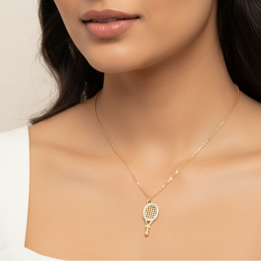 Gold necklace with crystal tennis racket pendant worn — model shot