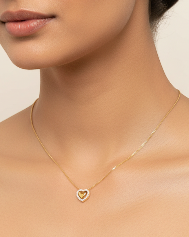 Fine gold necklace with small heart pendant worn — model shot