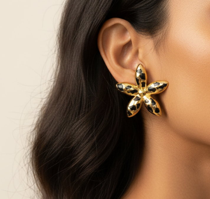 Gold leopard print flower stud earrings worn — model shot